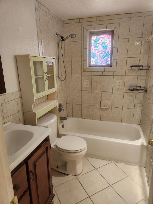 full bath featuring a textured ceiling, bathtub / shower combination, vanity, tile patterned floors, and toilet