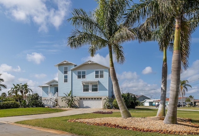 view of front of property with a garage, a front lawn, and concrete driveway