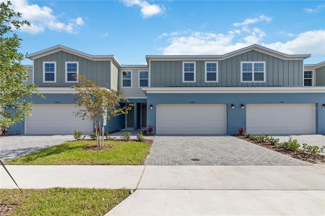 5240 Luisa Ct, Saint Cloud, FL 34771 - view of front of house with board and batten siding, a garage, and driveway
