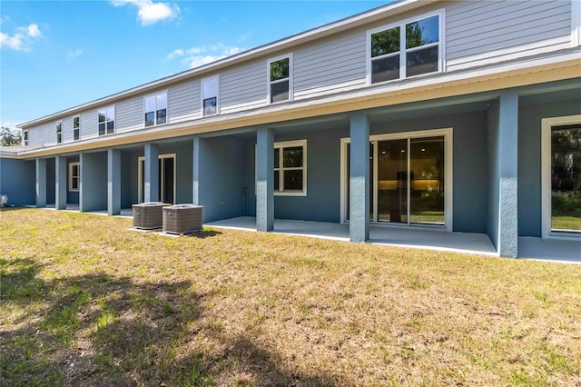 5240 Luisa Ct, Saint Cloud, FL 34771 - back of house featuring a patio area, central AC unit, stucco siding, and a yard