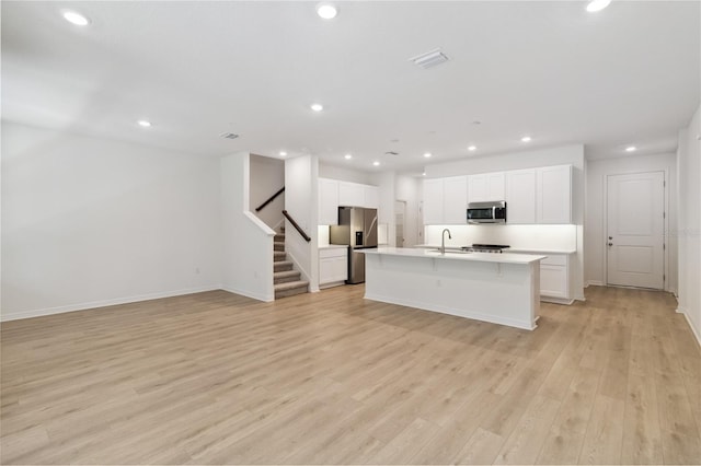 5240 Luisa Ct, Saint Cloud, FL 34771 - kitchen featuring stainless steel appliances, an island with sink, open floor plan, a sink, and recessed lighting