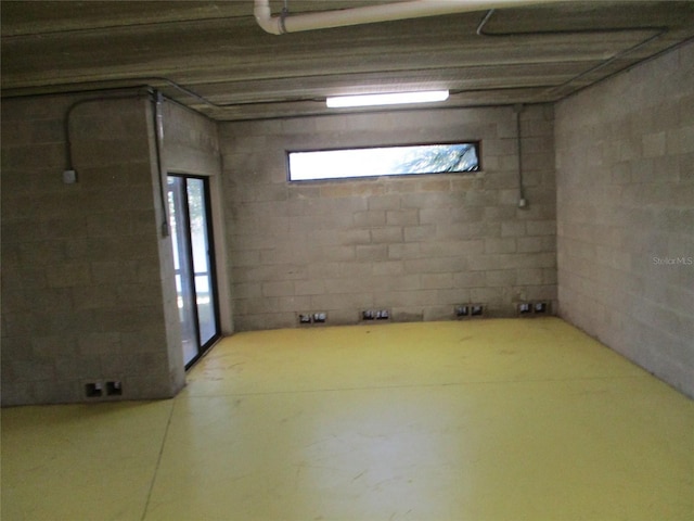 below grade area featuring concrete block wall