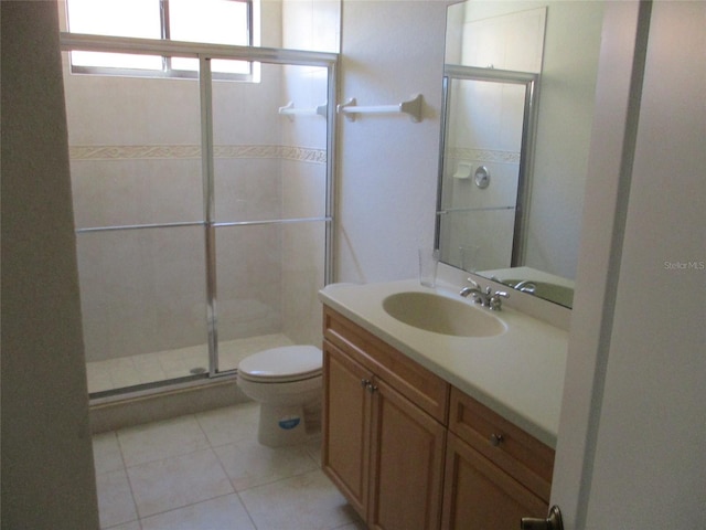 full bathroom featuring vanity, toilet, tile patterned flooring, and a stall shower