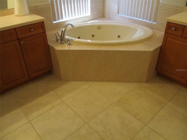 full bath featuring a whirlpool tub, tile patterned floors, and vanity
