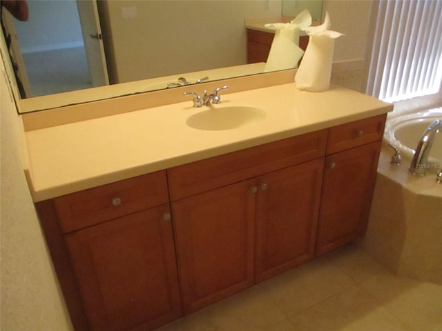 bathroom featuring vanity, tile patterned floors, and a washtub