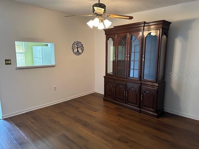 840 Virginia St Unit 202, Dunedin, FL 34698 - empty room with baseboards, ceiling fan, and dark wood-type flooring