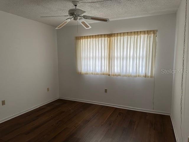 840 Virginia St Unit 202, Dunedin, FL 34698 - empty room with a textured ceiling, ceiling fan, and a healthy amount of sunlight