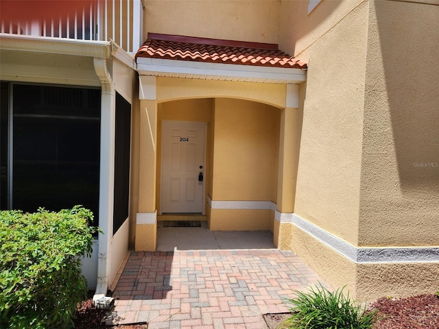 21008 Sunpoint Way Unit 204, Lutz, FL 33558 - entrance to property featuring stucco siding and a tile roof