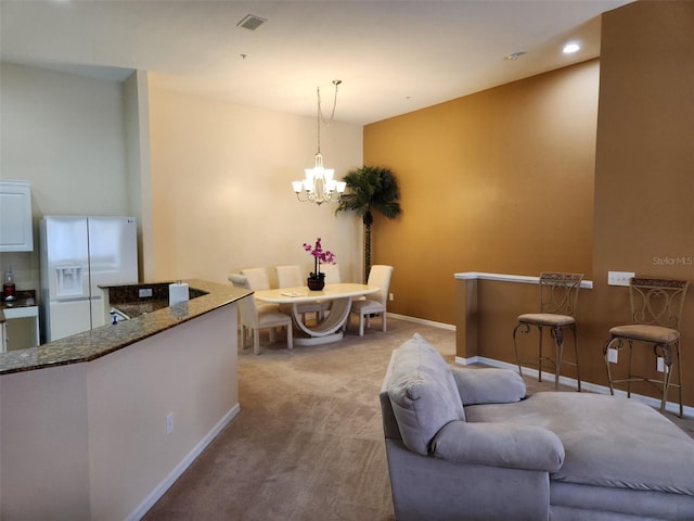 21008 Sunpoint Way Unit 204, Lutz, FL 33558 - carpeted living room with an inviting chandelier, recessed lighting, baseboards, and visible vents