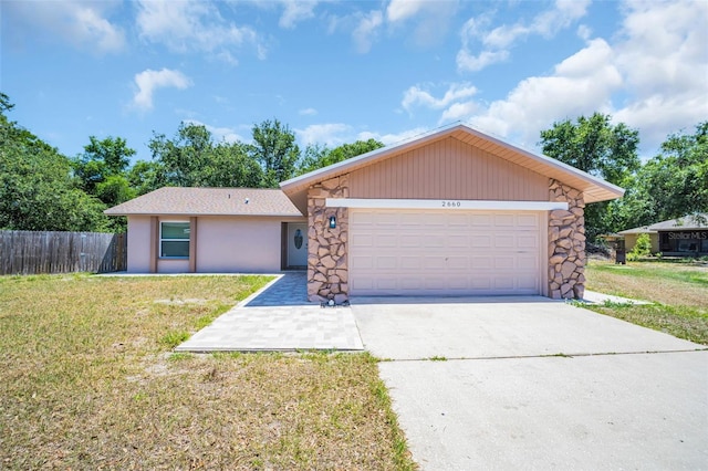 2660 Orangewood Ct, Palm Harbor, FL 34684 - single story home featuring fence, an attached garage, a front lawn, stone siding, and driveway