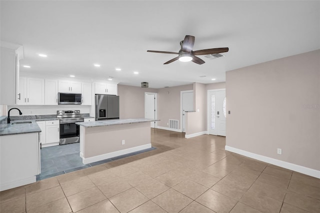 2660 Orangewood Ct, Palm Harbor, FL 34684 - kitchen featuring a kitchen island, visible vents, a sink, stainless steel appliances, and recessed lighting