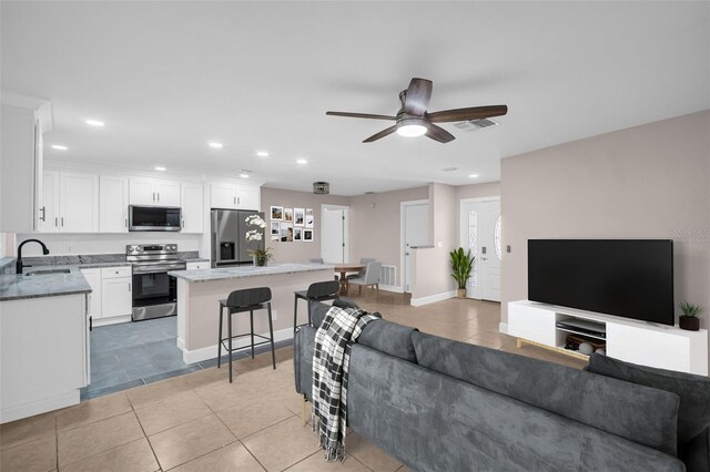 2660 Orangewood Ct, Palm Harbor, FL 34684 - living room featuring a ceiling fan, recessed lighting, and light tile patterned flooring