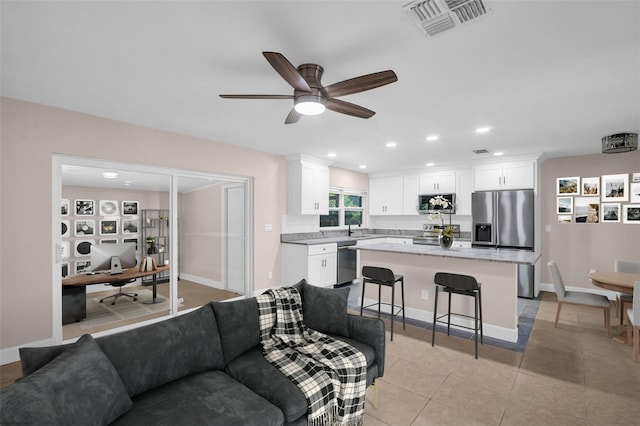 2660 Orangewood Ct, Palm Harbor, FL 34684 - living room featuring visible vents, baseboards, recessed lighting, a ceiling fan, and light tile patterned floors