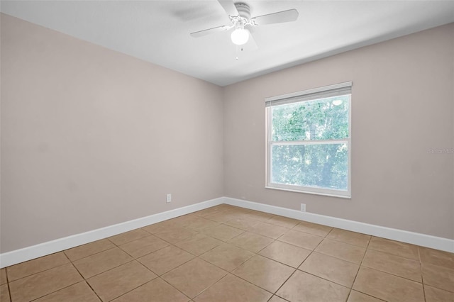 2660 Orangewood Ct, Palm Harbor, FL 34684 - unfurnished room with baseboards, a ceiling fan, and light tile patterned flooring