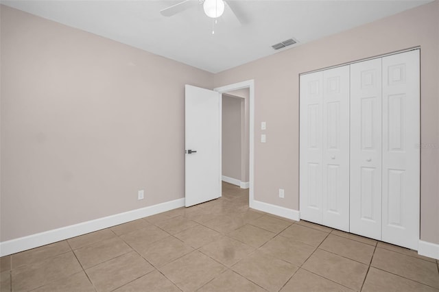 2660 Orangewood Ct, Palm Harbor, FL 34684 - unfurnished bedroom with light tile patterned floors, baseboards, ceiling fan, and visible vents