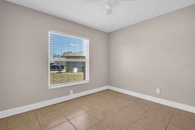 2660 Orangewood Ct, Palm Harbor, FL 34684 - tiled spare room with baseboards and ceiling fan