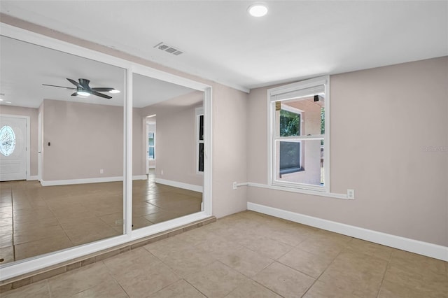 2660 Orangewood Ct, Palm Harbor, FL 34684 - tiled empty room with visible vents, baseboards, and ceiling fan
