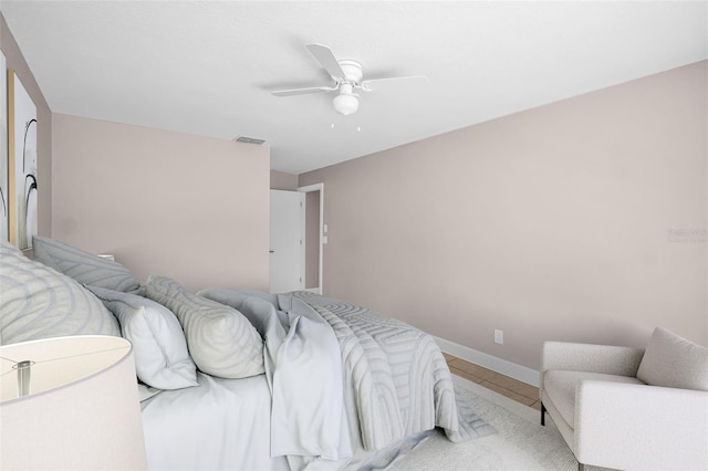 2660 Orangewood Ct, Palm Harbor, FL 34684 - bedroom with light tile patterned floors, baseboards, ceiling fan, and visible vents
