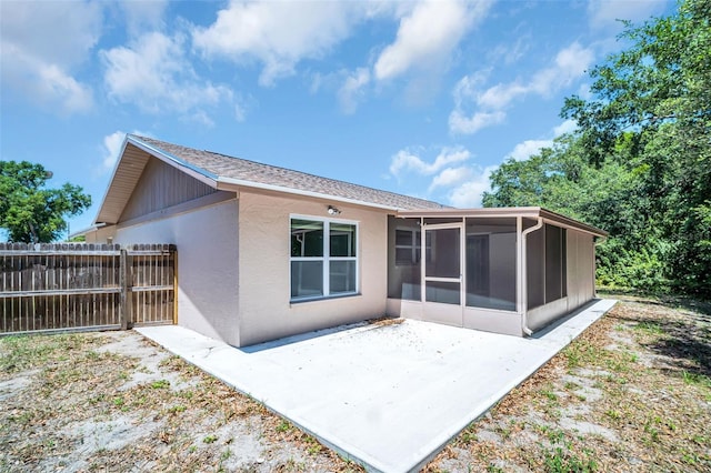 2660 Orangewood Ct, Palm Harbor, FL 34684 - rear view of property with a sunroom, stucco siding, fence, and a patio