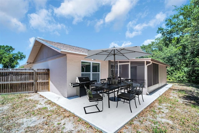 2660 Orangewood Ct, Palm Harbor, FL 34684 - rear view of property featuring a patio, fence, a sunroom, and stucco siding