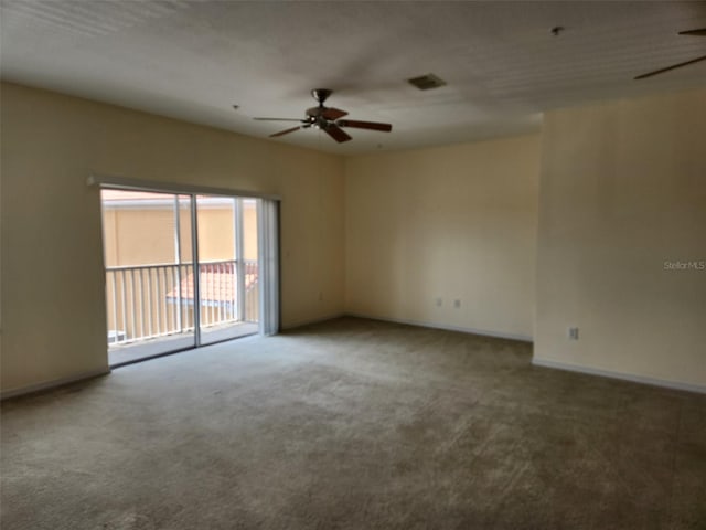 carpeted empty room with a ceiling fan, baseboards, and visible vents