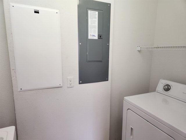 laundry room featuring electric panel, washer / clothes dryer, and laundry area