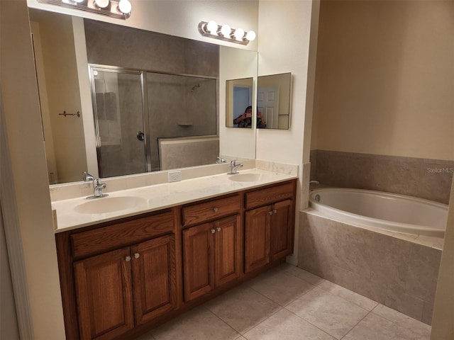 bathroom with a sink, tile patterned flooring, a shower stall, and a garden tub