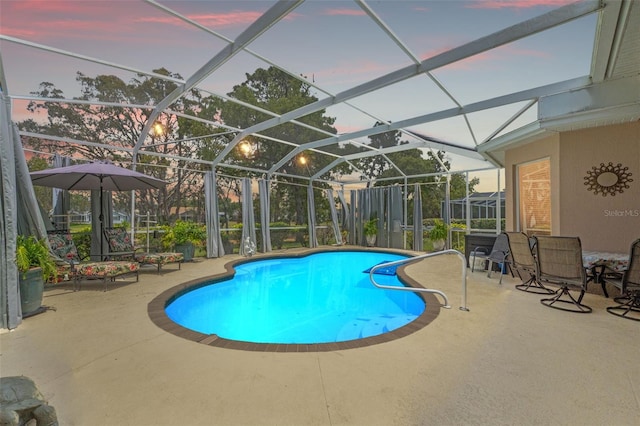 outdoor pool with a lanai and a patio area
