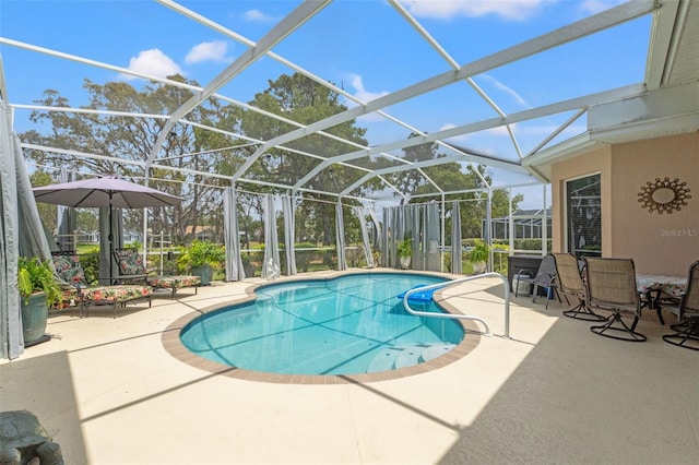 outdoor pool featuring glass enclosure and a patio area