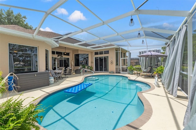 outdoor pool with a ceiling fan, a patio area, and a lanai