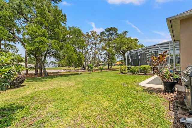 view of yard with glass enclosure