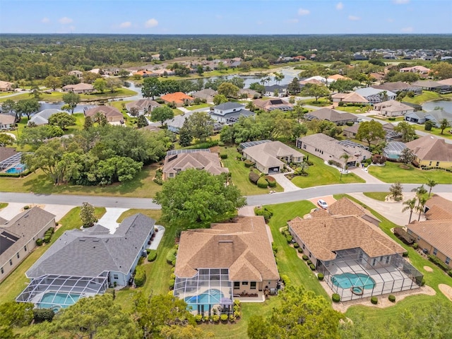 birds eye view of property featuring a water view and a residential view