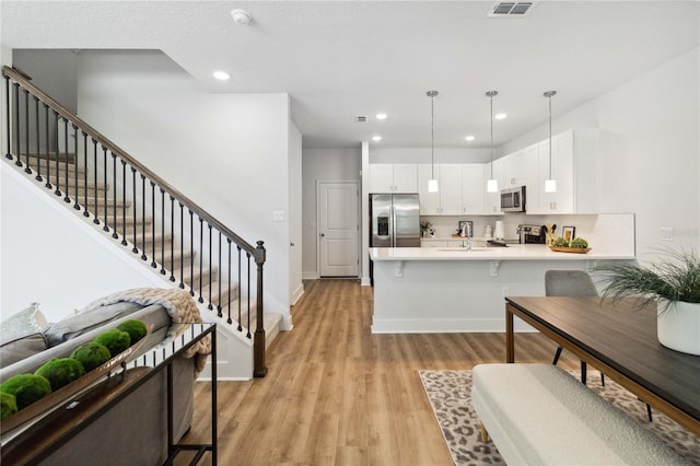 3307 Grande Heron Dr, Saint Cloud, FL 34773 - interior space featuring light wood-type flooring, recessed lighting, and stairway