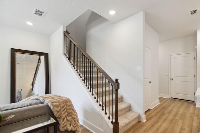 3307 Grande Heron Dr, Saint Cloud, FL 34773 - staircase featuring visible vents, recessed lighting, and wood finished floors