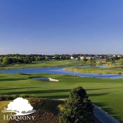 3307 Grande Heron Dr, Saint Cloud, FL 34773 - view of property's community with a water view, golf course view, and a yard