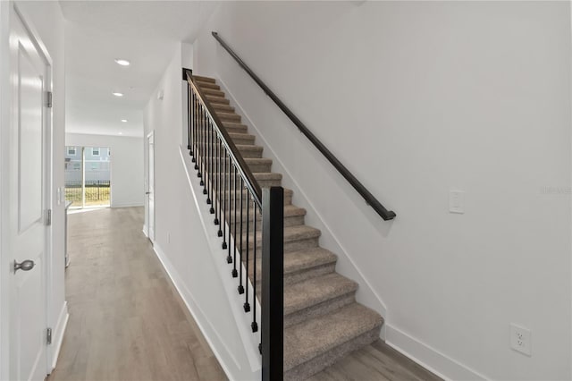 stairs featuring baseboards, recessed lighting, and wood finished floors