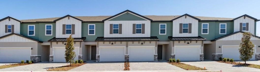 1100 Desert Candle Dr, Ocoee, FL 34761 - view of property featuring a standing seam roof, board and batten siding, and a metal roof