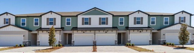 1100 Desert Candle Dr, Ocoee, FL 34761 - view of property featuring a standing seam roof, board and batten siding, and a metal roof