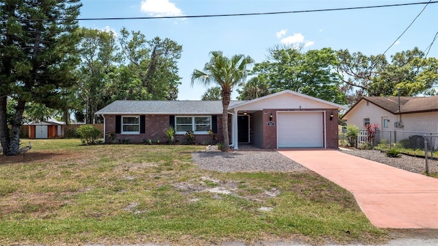 8522 Inwood Dr, Hudson, FL 34667 - single story home with brick siding, fence, a front lawn, concrete driveway, and an attached garage
