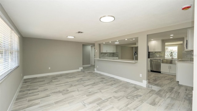 8522 Inwood Dr, Hudson, FL 34667 - unfurnished living room with a sink, baseboards, recessed lighting, and visible vents