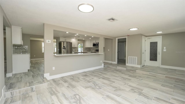 8522 Inwood Dr, Hudson, FL 34667 - kitchen with decorative backsplash, stainless steel appliances, and visible vents