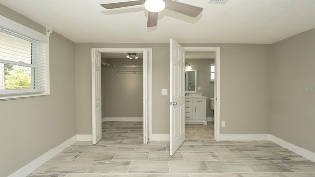 8522 Inwood Dr, Hudson, FL 34667 - unfurnished bedroom featuring baseboards, ceiling fan, and a closet