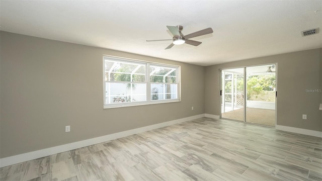 8522 Inwood Dr, Hudson, FL 34667 - unfurnished room featuring visible vents, a ceiling fan, baseboards, and light wood finished floors