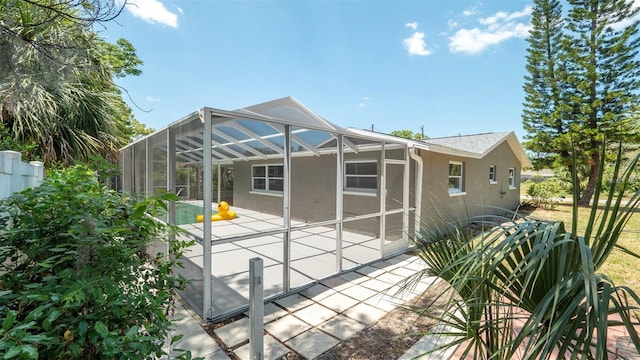 8522 Inwood Dr, Hudson, FL 34667 - back of property featuring a lanai, a patio area, stucco siding, and an outdoor pool