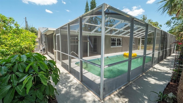 8522 Inwood Dr, Hudson, FL 34667 - view of property exterior with a lanai, a patio, stucco siding, and an outdoor pool