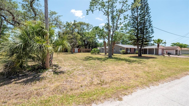 8522 Inwood Dr, Hudson, FL 34667 - view of yard with a storage unit and an outbuilding