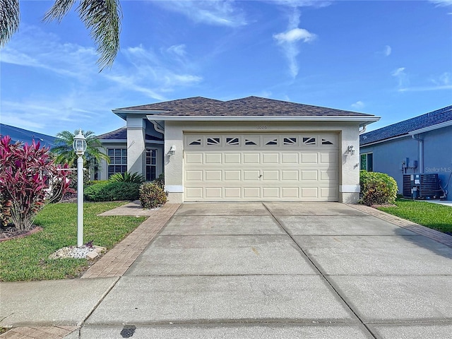 single story home featuring cooling unit, stucco siding, concrete driveway, and a garage