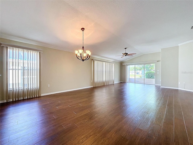empty room with a chandelier, dark wood-type flooring, ceiling fan, lofted ceiling, and baseboards