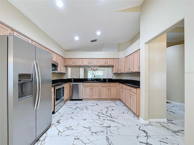 kitchen with stainless steel appliances, light marble finish flooring, light brown cabinetry, recessed lighting, and dark countertops