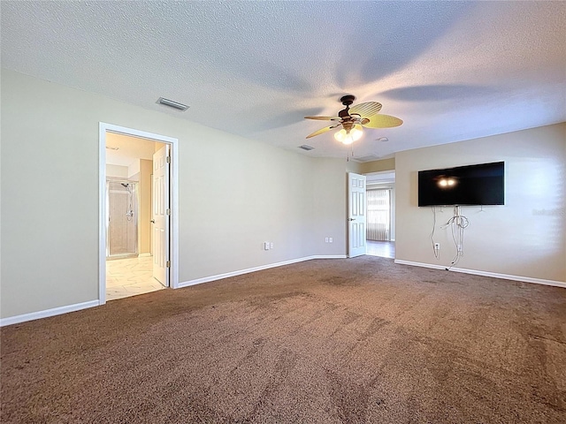unfurnished living room featuring carpet, a ceiling fan, baseboards, and a textured ceiling